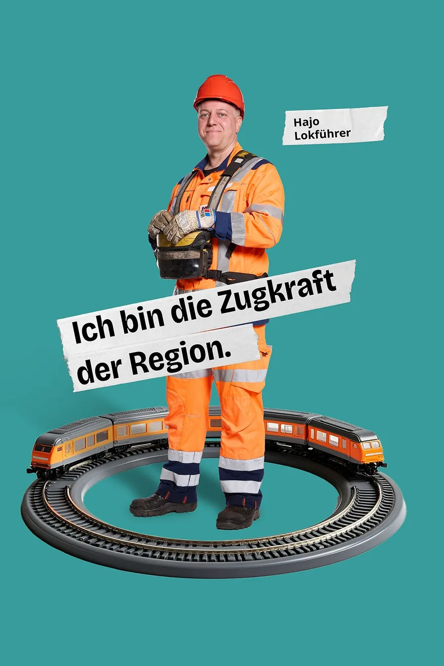 Motiv der Kampagne: Lokführer Hajo in Warnkleidung steht in einer Spielzeugeisenbahn, Text „Ich bin die Zugkraft der Region.“